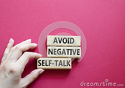 Avoid negative self-talk symbol. Concept words Avoid negative self-talk on wooden blocks. Beautiful red background. Businessman Stock Photo