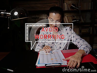 AVOID WORRYING text in block of quotes. Businesswoman doing paperwork Stock Photo
