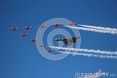 The Avro Vulcan XH558 being escorted by the Red Arrows Editorial Stock Photo