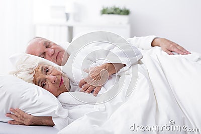 Awaken wife and sleeping husband Stock Photo