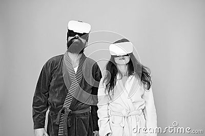 Awakening from virtual reality. Couple in bathrobes wear vr glasses. Conscious awakening. Return to reality. Man and Stock Photo