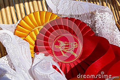 Award rosettes in equestrian sport with red and yellow colors Stock Photo