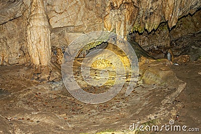 Awe-inspiring scene of a mysterious rocky cave featuring stunning mineral formations Stock Photo