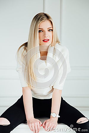 Awesome caucasian attractive professional female model with blond hair posing in studio. Stock Photo