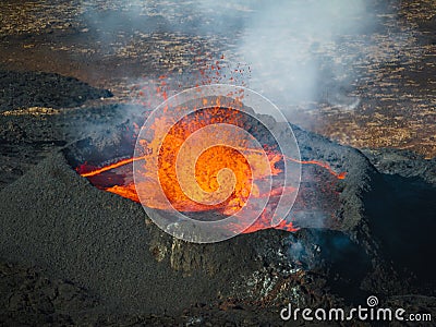 Close up view of boiling lava lake inside volcano crater, drone top down shot Stock Photo