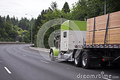 Awesome customized big rig white and green semi truck with flat Stock Photo