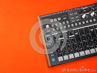 Electronic musical instrument or audio mixer or sound equalizer on a orange background analog modular synthesizer Stock Photo