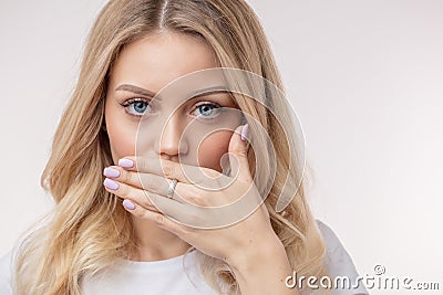 An awesome lady with hand on the mouth. nice woman has revealed the secret. Stock Photo