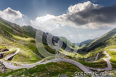 Awesome Sunny Landscepe in Romania Mountains. Scenic image Fairytale valley with Asphhalt road, and sky under sunlight on a Stock Photo