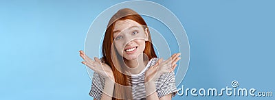 Awkward apologizing cute redhead girlfriend say sorry shrugging spread hands sideways puzzled smiling uncomfortably Stock Photo