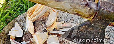 Ax stuck in the stump of wood chips, wide view, concept of a flyer or banner about life in the village Stock Photo