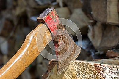 Axe in front of a stack of wood Stock Photo