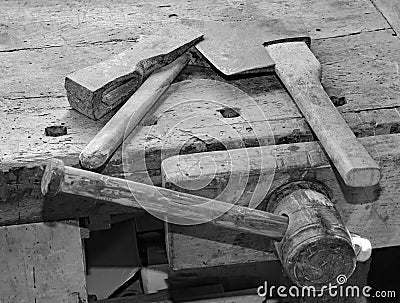 axe and hammer on the old wooden workbench and old balck and whi Stock Photo
