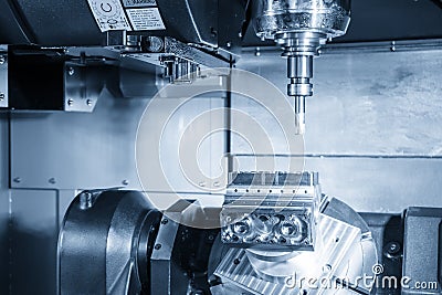 The 5-axis CNC milling machine cutting the sample of aluminium engine parts by solid ball endmill tools. Stock Photo