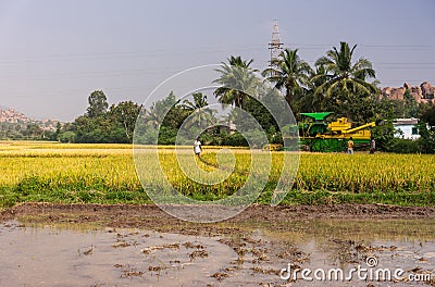 Pick thresher, in rice field, behind mud, Ayodhya, Karnataka, India Editorial Stock Photo