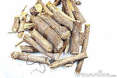 Ayurvedic herb Licorice root or Mulethi or Liquorice isolated on white. Stock Photo