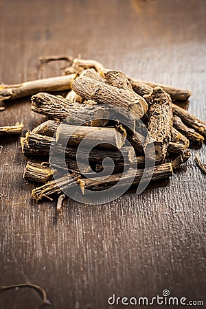 Famous ayurvedic herb Licorice root or Liquorice root or Mulethi on wooden surface. Stock Photo