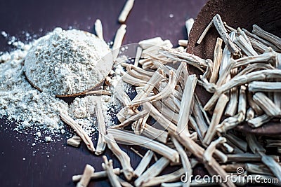 Ayurvedic herb Satavari with its powder on wooden surface. Stock Photo