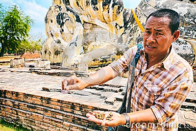 Ayutthaya, Thailand -13 February, 2014: Undefined vendor seller in Reclining Buddha at Wat Lokayasutharam. Editorial Stock Photo