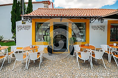 Shopfront selling local products such as cake, cheese and wine built in traditional Portuguese architecture in the Editorial Stock Photo