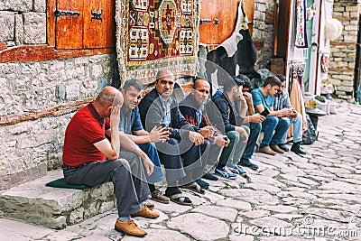 Azeri Men sitting and talking in the Street on cobblestone Huseynov street, the main street of Lahic mountainous village of Azerba Editorial Stock Photo