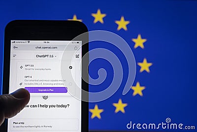 User holding Smartphone with ChatGPT version 3.5 and the European flag on the background. ChatGPT developed by OpenAi Editorial Stock Photo