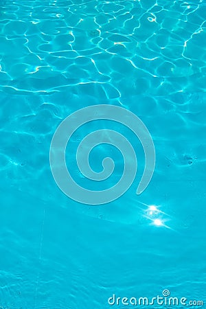 Azure transparent texture of water in a blue pool with splashes from the sun Stock Photo