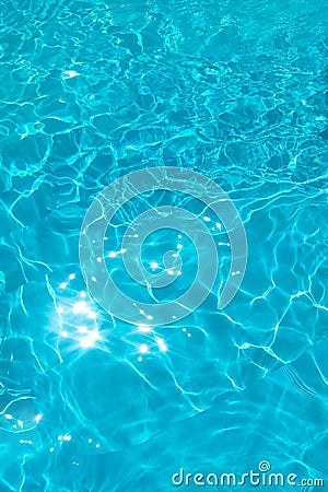 Azure transparent texture of water in a blue pool with splashes from the sun Stock Photo