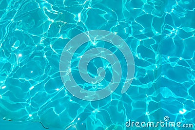 Azure transparent texture of water in a blue pool with splashes from the sun Stock Photo