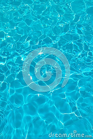 Azure transparent texture of water in a blue pool with splashes from the sun Stock Photo