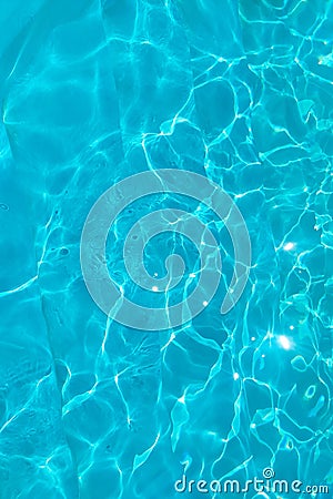 Azure transparent texture of water in a blue pool with splashes from the sun Stock Photo