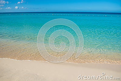 Azure turquoise calm sea, clear blue sky, sandy beach and flat horizon Stock Photo