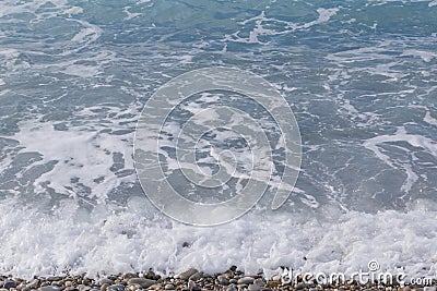 Azure waves on beach in Nice at summer Stock Photo