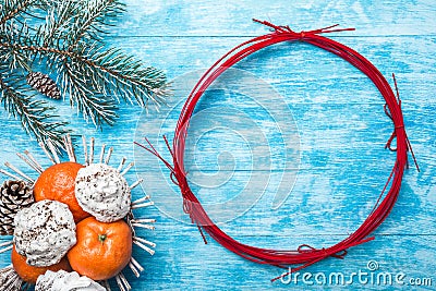 Azure wood background. Green fir tree. Fruit with mandarin and sweets. Circle for Christmas or New Year. Stock Photo