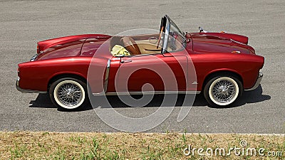 Exclusive convertible red Fiat, a roadster of the Sixties, on the roadside, Editorial Stock Photo