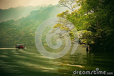 Ba Be lake, Bac Kan province, Vietnam - April 4, 2017 : tourists on the boat are going to enjoy and explore Ba Be lake. Editorial Stock Photo
