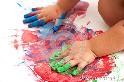 Babies hands painting colorful mosaic. Stock Photo