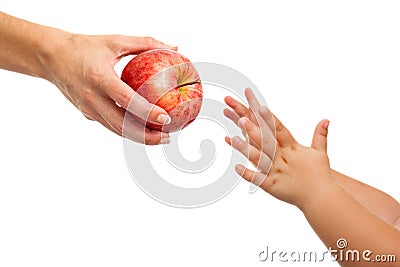 Babies hands reaching out to apple. Stock Photo