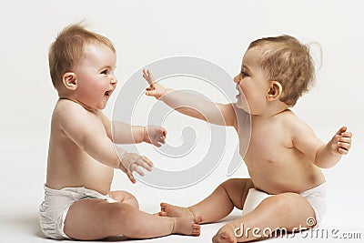 Babies Playing On White Background Stock Photo