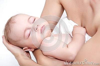 Baby asleep on hands of mother Stock Photo
