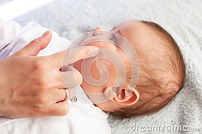 Baby with atopic dermatitis getting cream put. Care and Prevention Of Eczema Stock Photo