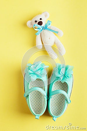 Baby background with bear toy and turquoise shoes for baby girl Stock Photo
