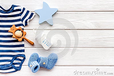 Baby background - blue color. Clothes and accessories for newborn boy on white wooden table top-down frame copy space Stock Photo