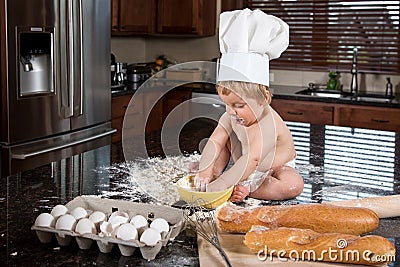 Baby Baker Sitting in Kitchen Stock Photo