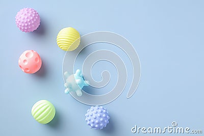 Baby balls toys for bath on blue background. Flat lay, top view. Minimal style Stock Photo