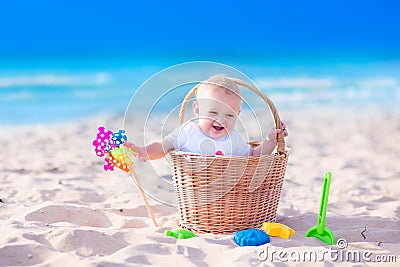 Baby in a basket on the beach Stock Photo