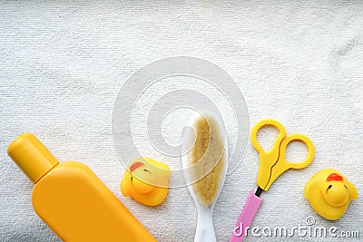 Baby bath products on white towel with copy space, child shampoo mockup,yellow duck, hair brush Stock Photo