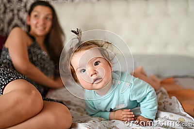 Baby in bed. Cute baby lies. Smiling baby. funny comb Stock Photo