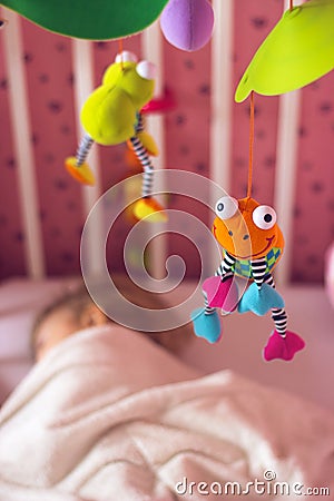 Baby bed with mobile toy above it Stock Photo