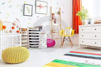 Baby bedroom with yellow pouf Stock Photo
